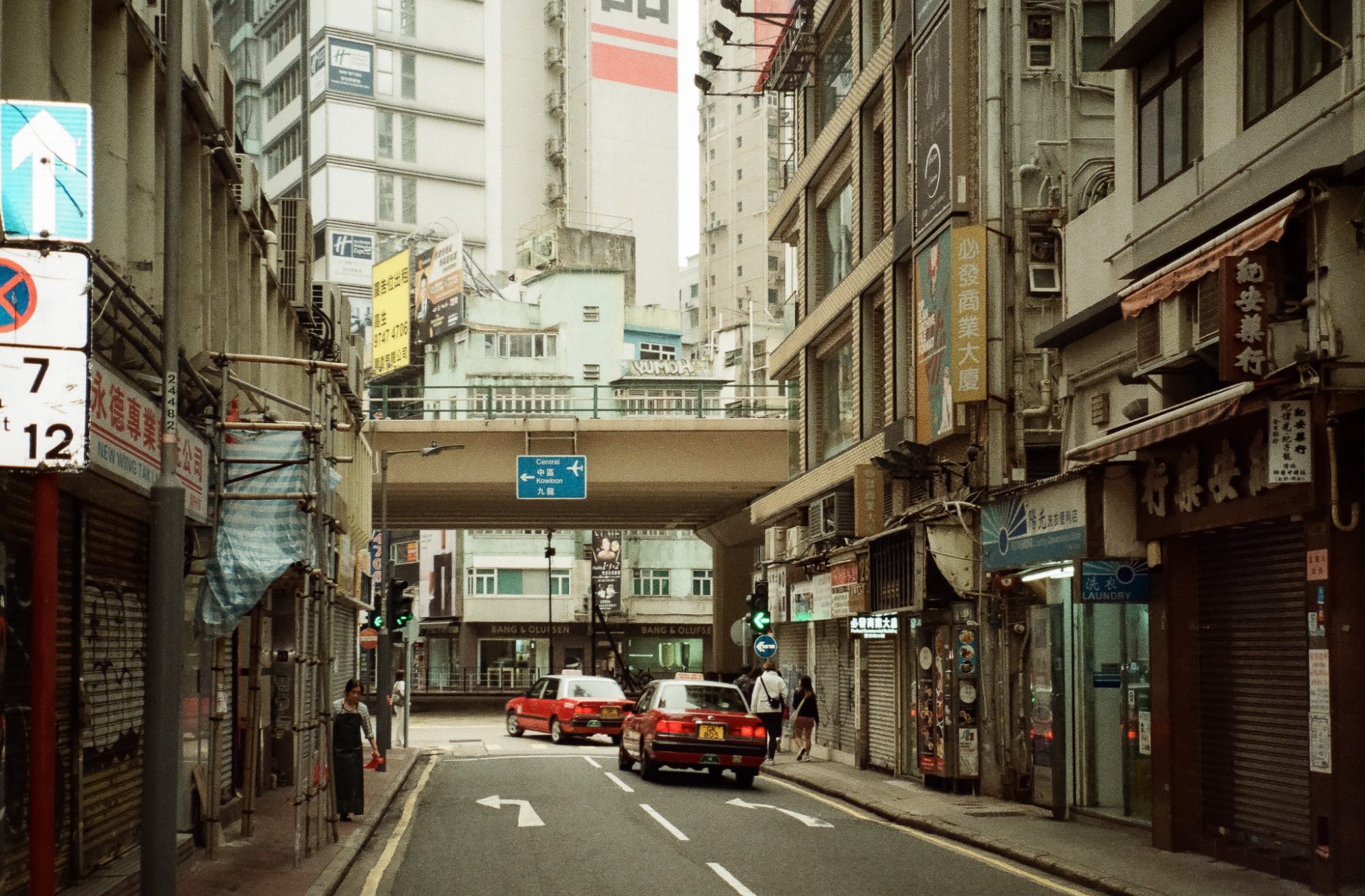 Red taxis under a flyover