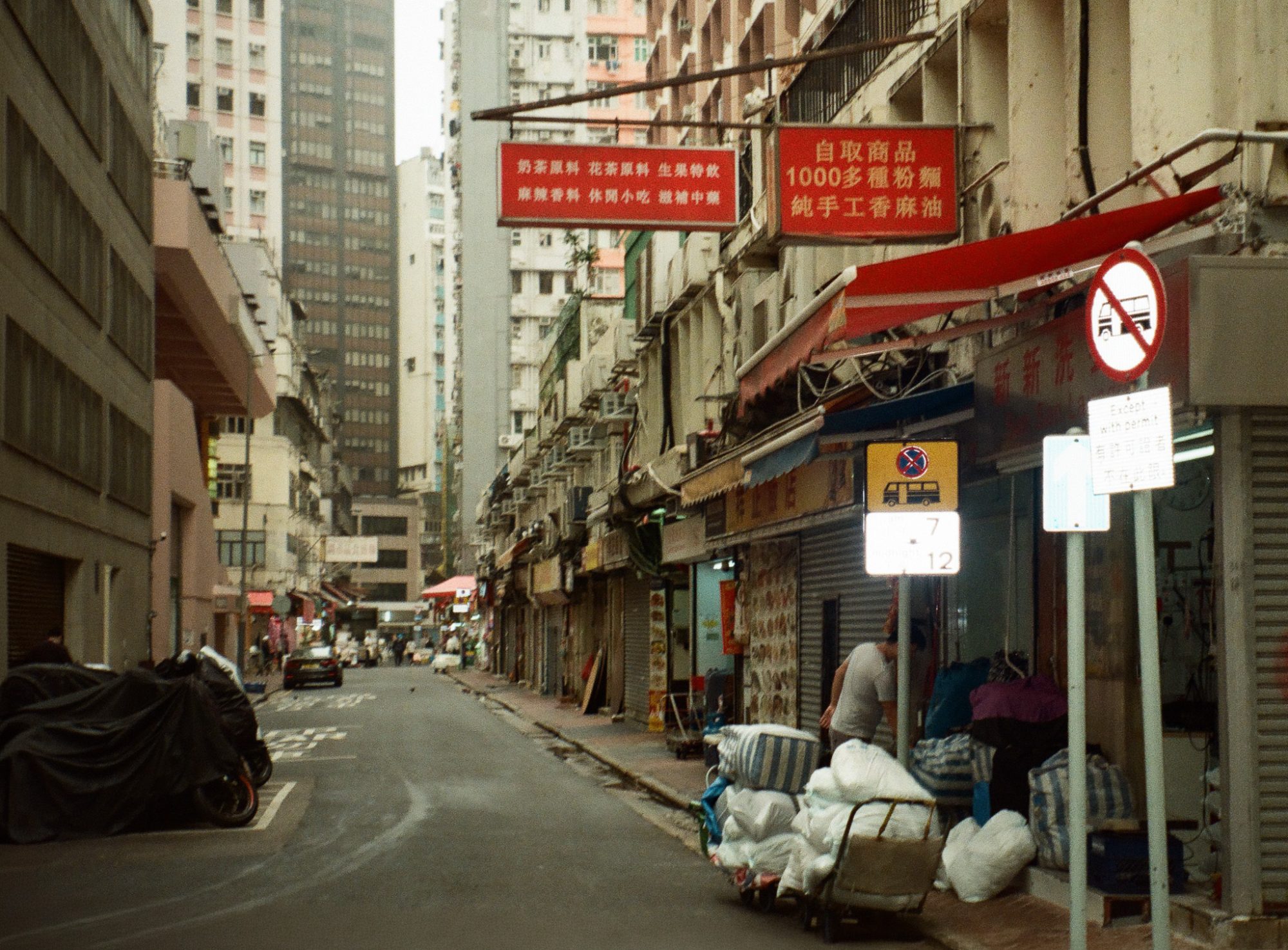 Shuttered street, sacks on a trolley