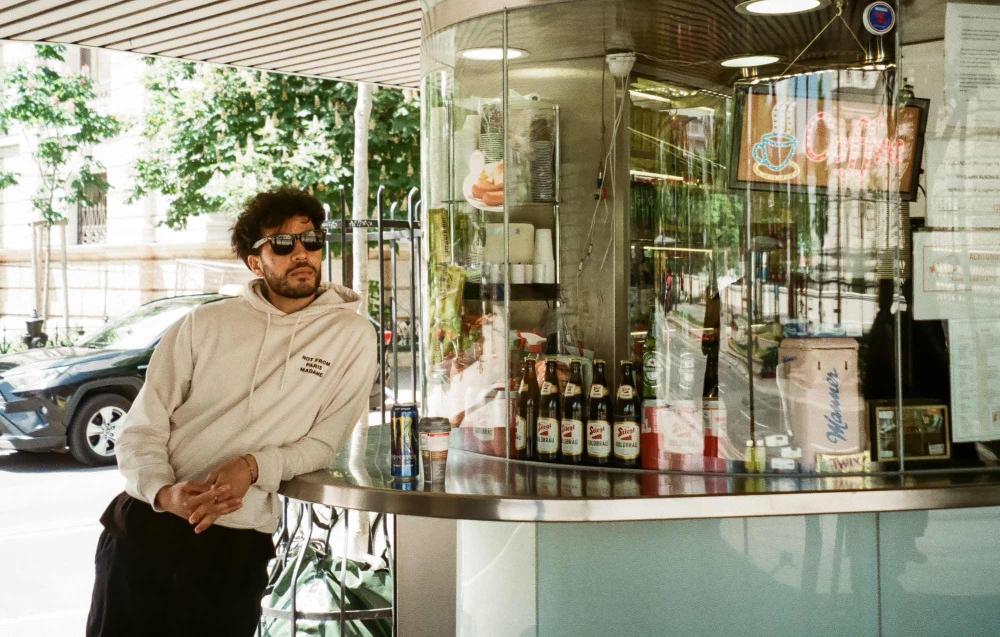 Man leaning on a kiosk counter