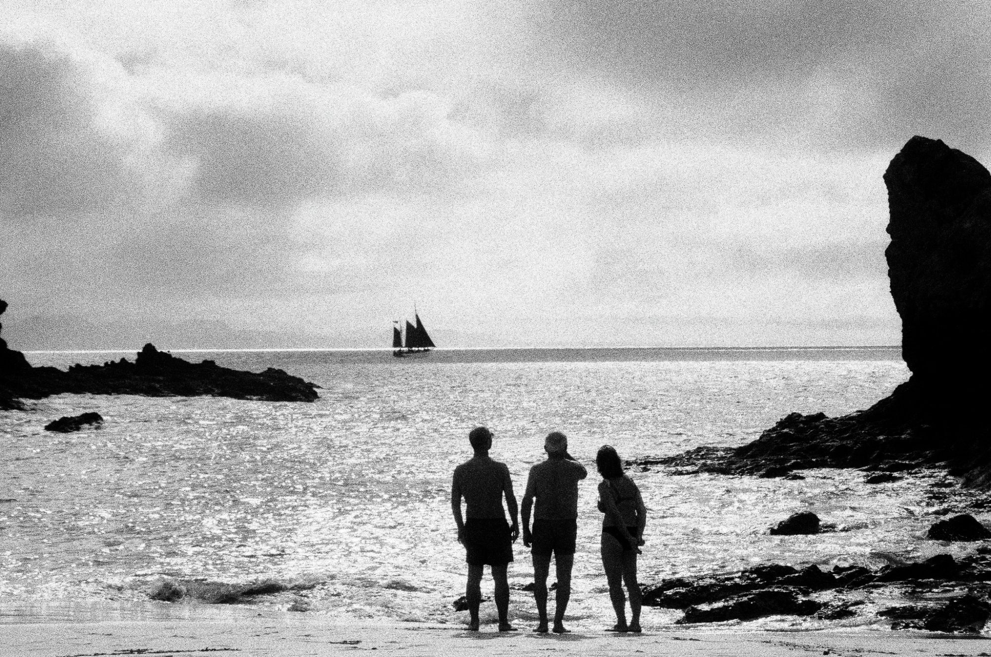 Three figures, one sail